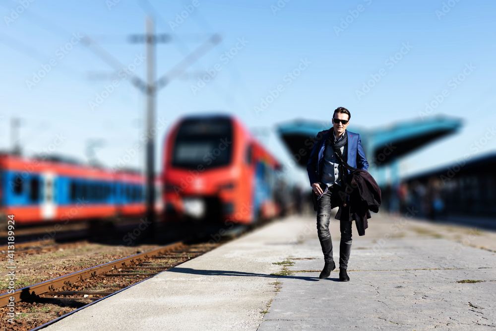 Full length of a businessman at railroad station platform.