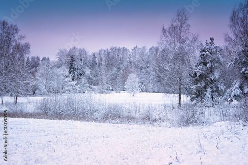 Winter wonderland in Latvian country side. Beautiful nature in sunset colors.