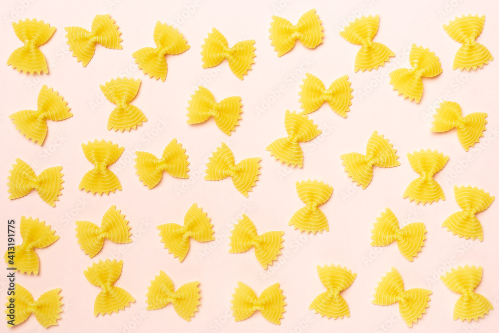 Bows of  farfalle type of pasta on pink background.