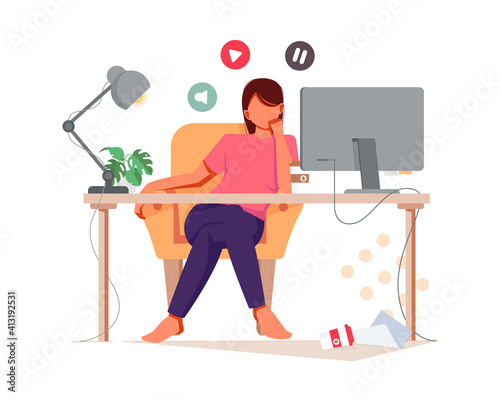Single woman watching online computer in the night sitting on a couch in the living room at home