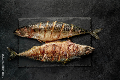 grilled mackerel with lime and spices on stone background