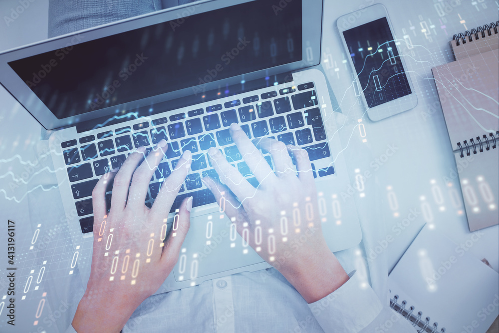 Double exposure of woman hands working on computer and forex chart hologram drawing. Top View. Financial analysis concept. Double exposure of woman hands working on computer and forex chart hologram drawing. Top View. Financial analysis concept.