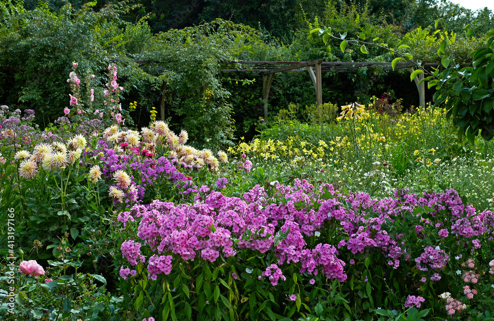 A colourful flower border in a French country garden A colourful flower border in a French country garden