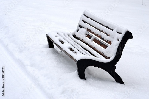 snowy bench in winter park, Senov, North Moravia, Czech Republic photo