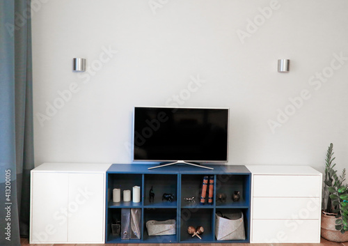 interior light gray with blue TV on the pedestal