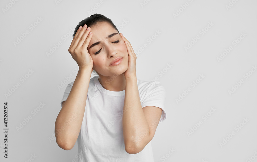 woman holding face headache and migraine health problems woman holding face headache and migraine health problems