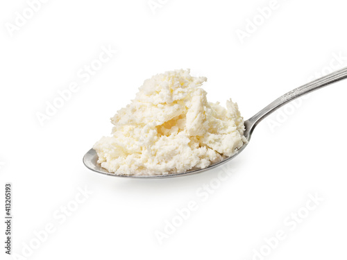 Spoon of fresh cottage cheese isolated on white background.