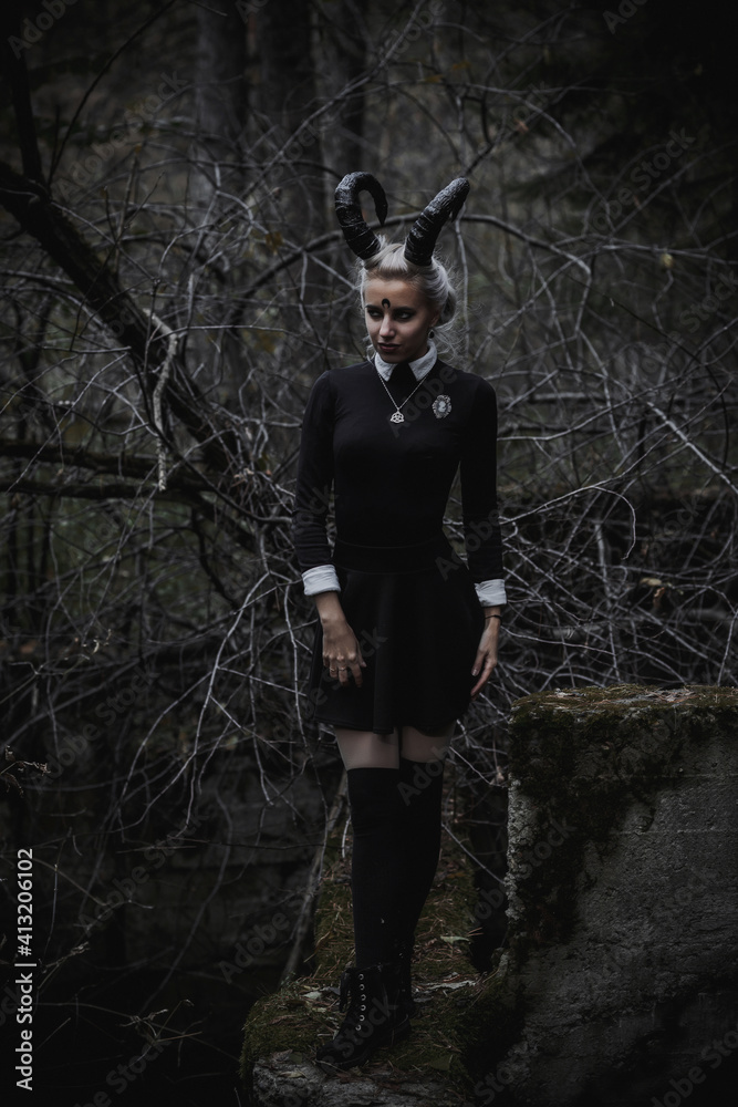 Naklejka premium Witch in the form of a student in the forest