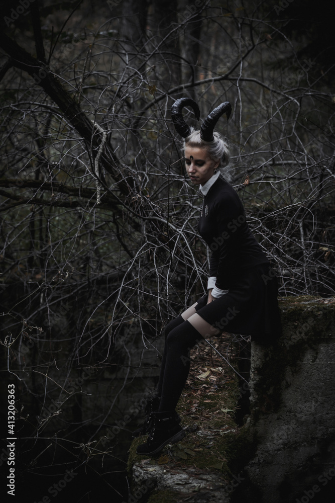 Naklejka premium Witch in the form of a student in the forest