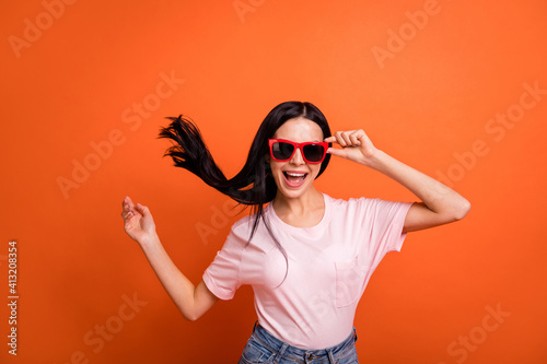 Photo of impressed brunette lady wear spectacles pink t-shirt isolated on bright orange color background