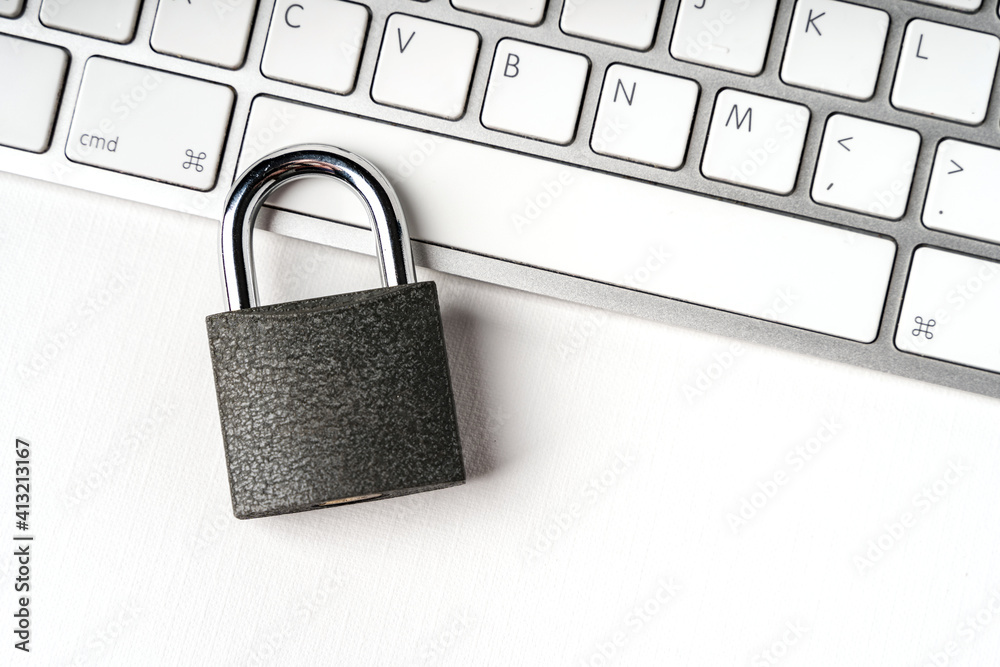 Concept of a computer security. Locked padlock on a white laptop keyboard. Concept of a computer security. Locked padlock on a white laptop keyboard.