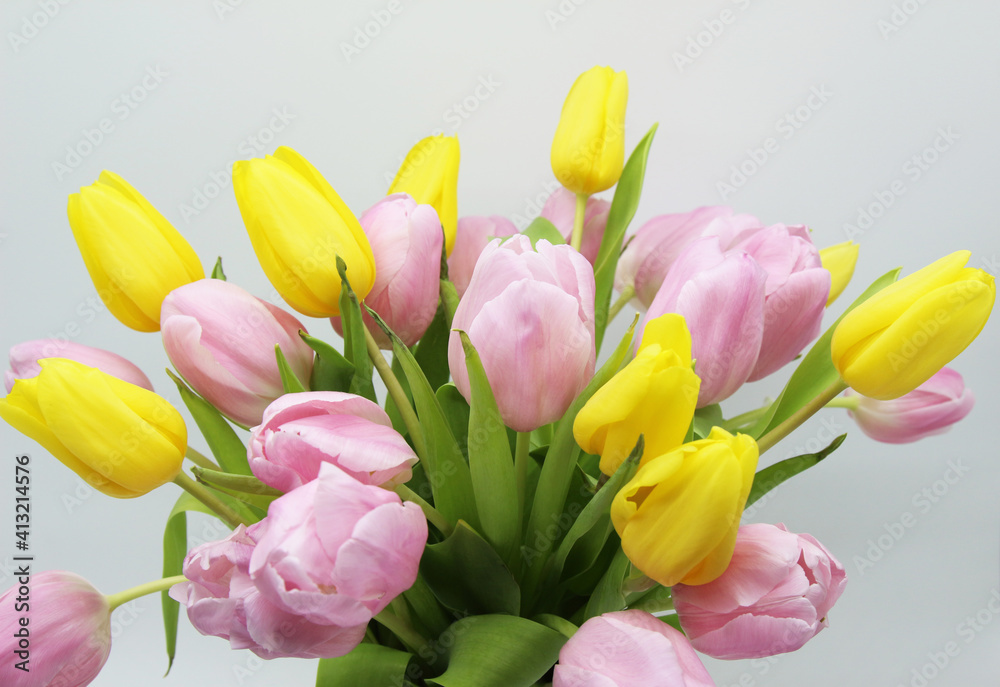 lush bouquet of pink and yellow tulips on a white background