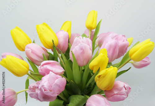 Fototapeta Naklejka Na Ścianę i Meble -  lush bouquet of pink and yellow tulips on a white background