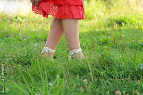 Woman legs standing in grass. A country girl on a farm. Natural organic farming