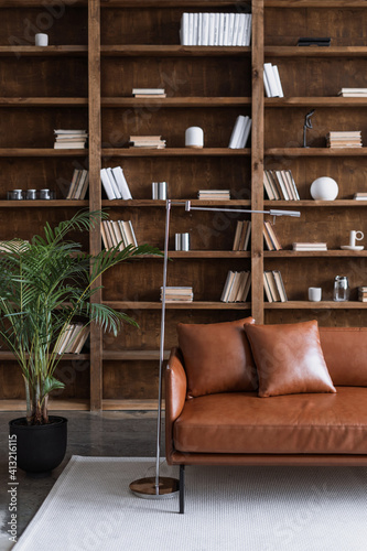 Room with comfortable couch and books on bookshelves