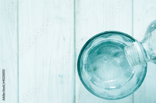 A glass with pure clear melt water stands on a white table