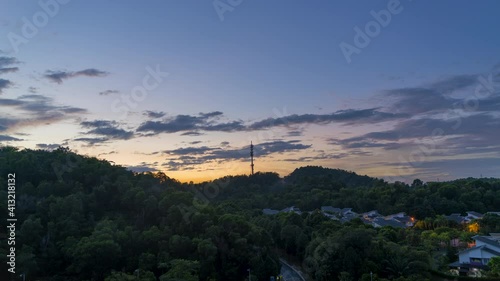 Cinematic Timelapse footage circle view of 5G Communication tower during morning sunrise with clouds, mists and fog