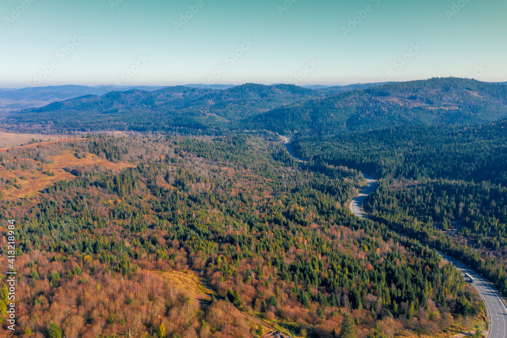 Obraz premium View of the mountains and winding highway in autumn. Beautiful nature landscape. Carpathian mountains. Ukraine