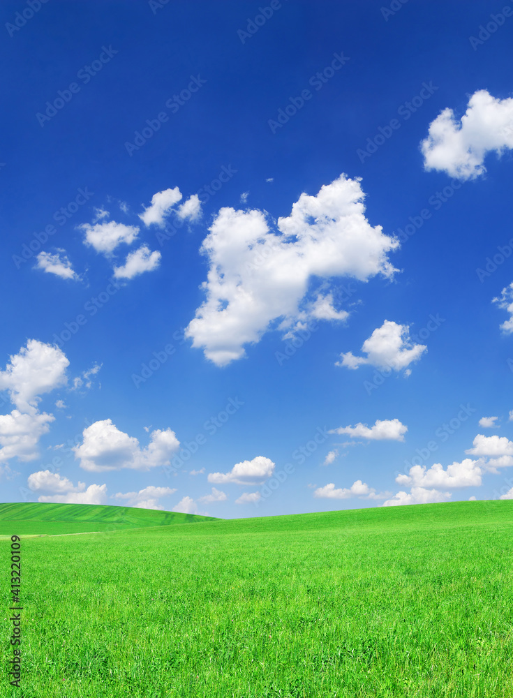 Idyllic view, green hills and blue sky with white clouds