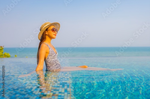 Portrait beautiful young asian woman relax smile enjoy leisure around swimming pool