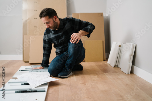 Portrait of man assembling furniture. Do it yourself furniture assembly.