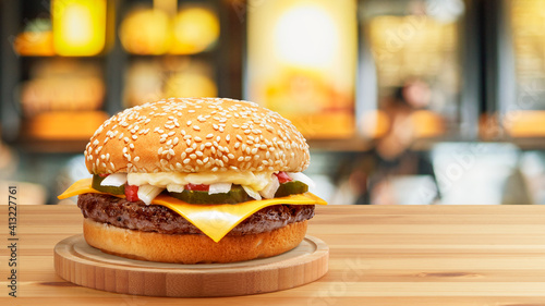 Delicious Cheese Beef Burger consists of Bun Bread Patty Pickle Onion Mayonaisse Ketchup Cheddar Cheese and lettuce in a yellow background with interactive 3D text for Modern Fast Food Restaurant photo