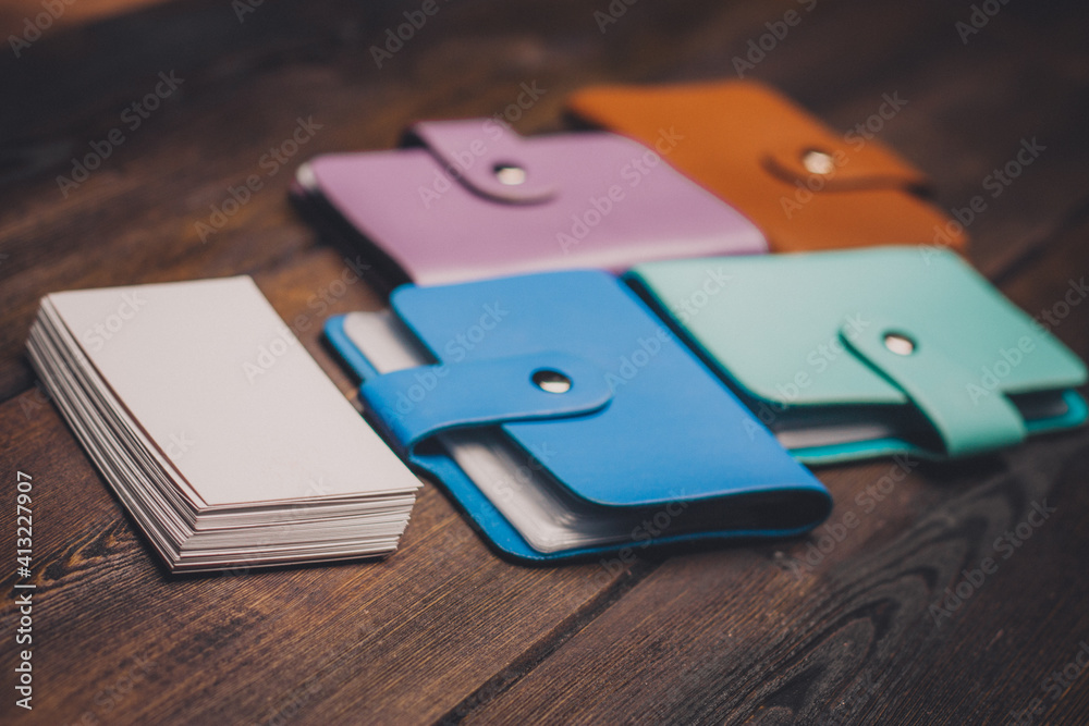 bright business card holders and a pack of white paper on a wooden background close-up bright business card holders and a pack of white paper on a wooden background close-up