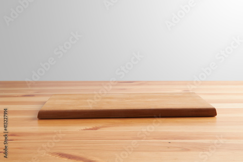 new rectangular wooden cutting board  in top of wooden table with a minimalistic limbo background