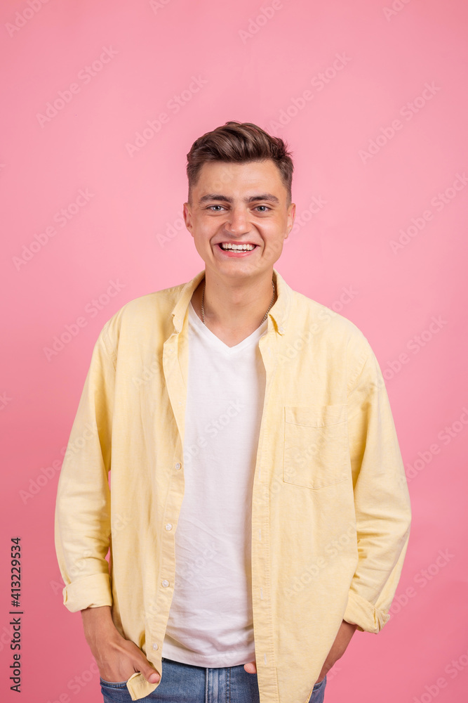 Portrait of a satisfied young man celebrating success isolated over pink background Portrait of a satisfied young man celebrating success isolated over pink background