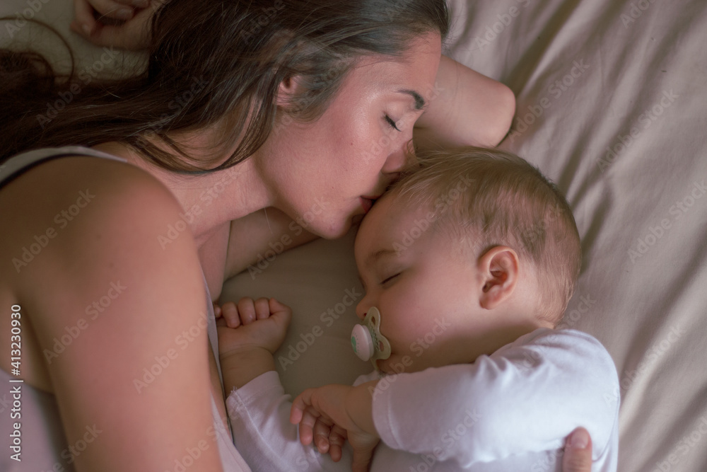 Mother and her baby sleeping together happy Mother and her baby sleeping together happy