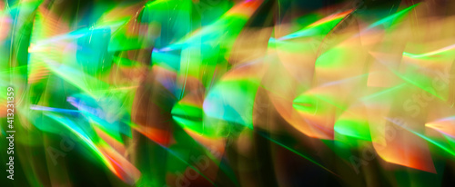 Blurred Light painting one exposure in camera. light glares with a spectral gradient on a dark background. Multicolored abstract colorful line. Unusual light effect.