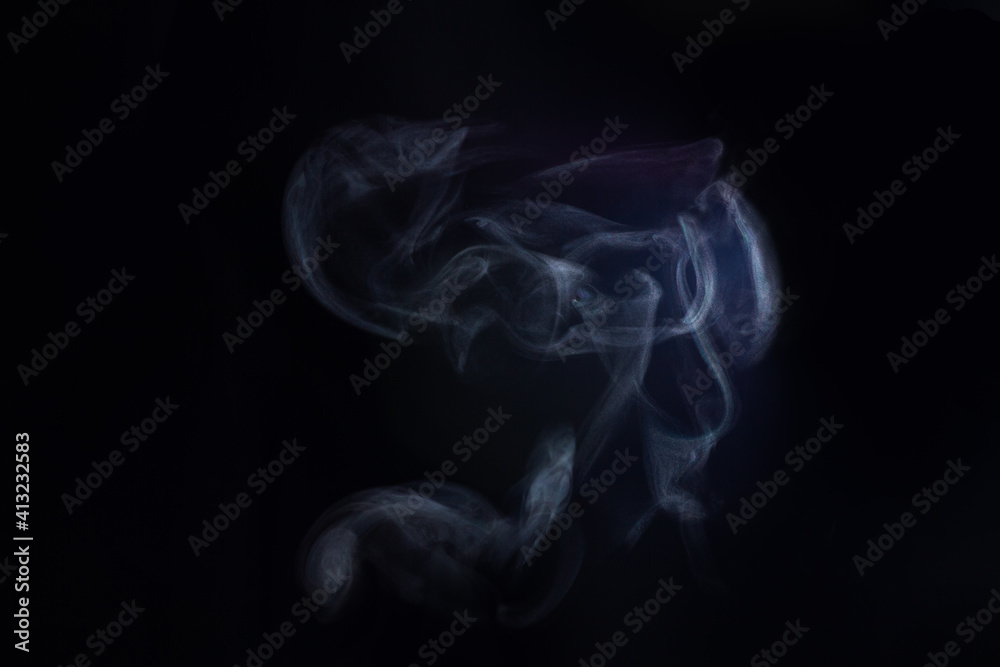 A cloud of steam from hot water on a black background A cloud of steam from hot water on a black background