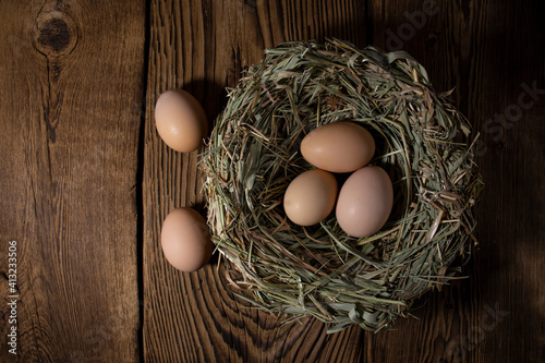 Easter eggs in a basket on a vintage wooden background. eggs in the nest with copy space