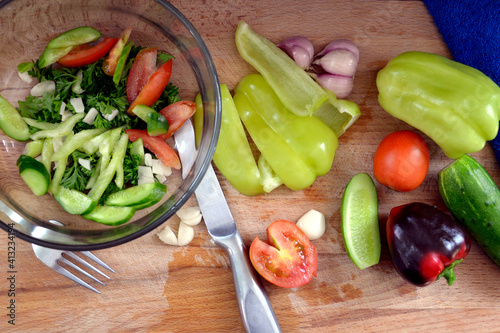 Vegetable salad in a glass bowl. Chopped vegetables for making vitamin salad. Diet food.