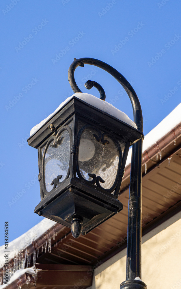 Vintage iron street lamp in winter day