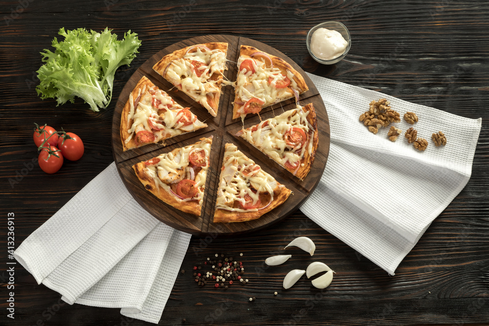 Delicious pizza on a wooden cutting board