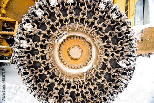 Tractor tires with chains in the snow.