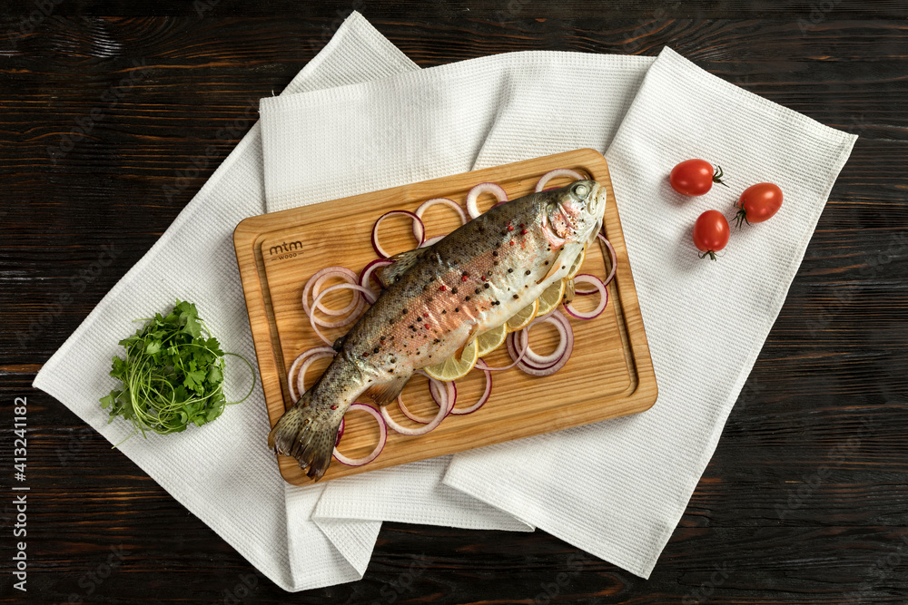 baked rainbow trout on a wooden board for serving