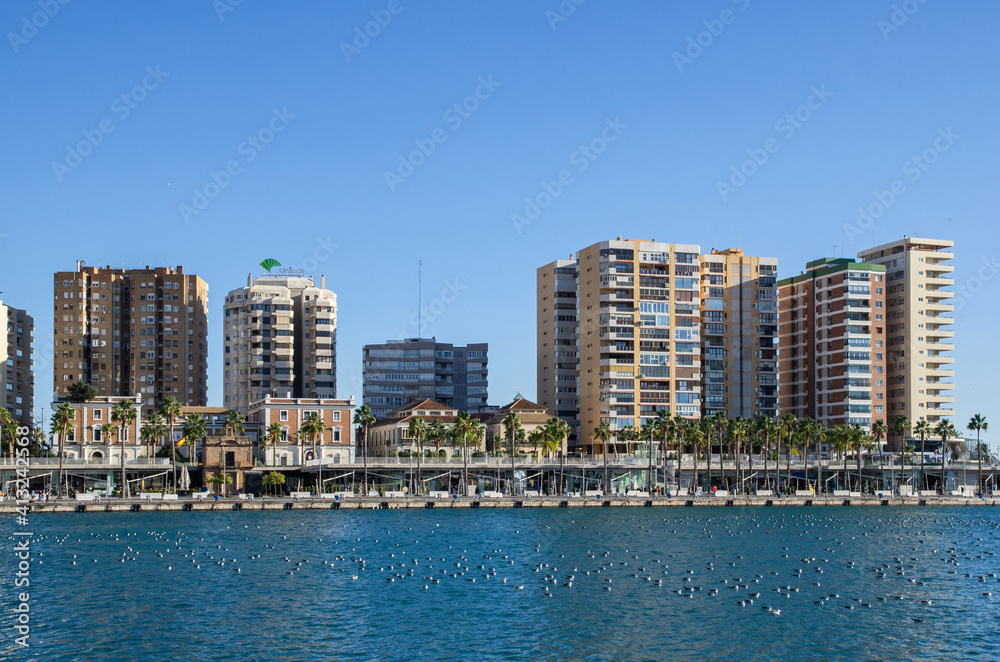 View of waterfront with many shops and restaurants in Malaga. Visiting Andalusia, Spain.