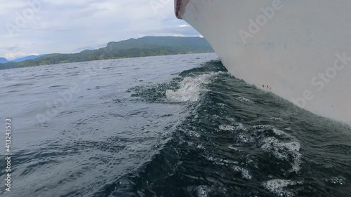 Boat Cutting Water Surface And Approaching To Wild Tropical Land In Kaimana Island, Raja Ampat. Beautiful Ocean And Landscape In Papua, Indonesia. photo