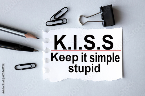 KISS, keep it simple, stupid. text on white paper on gray background