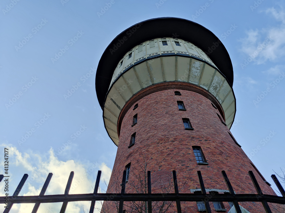 Old red brick water tower. Industrial architecture of Latvia. Agenskalns water storage tank.