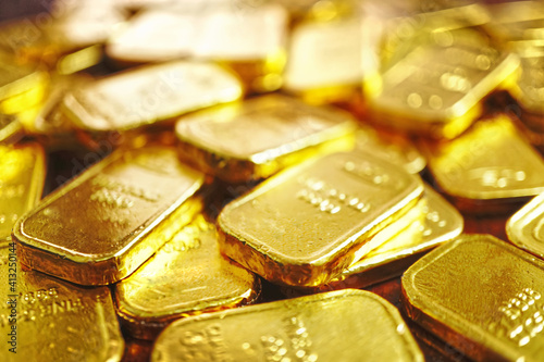 Selective focus on group of gold bars spread on the millonaire 's table , investment concept .