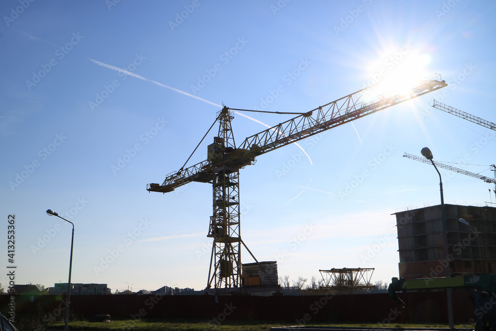 Tower cranes are working on the construction of a new house. Lifting crane. Tower cranes are working on the construction of a new house. Lifting crane.
