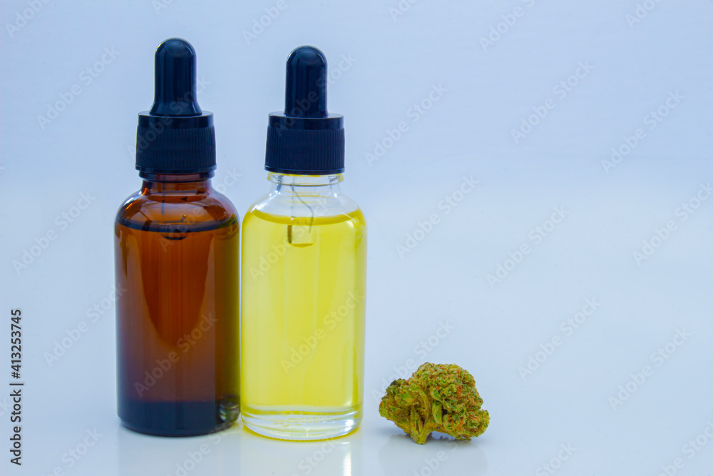A Couple of Cannabis Dropper Bottles with a cannabis flower. Portable Oil Glass Bottle, Cannabis Oil Bottle. A Couple of Cannabis Dropper Bottles with a cannabis flower. Portable Oil Glass Bottle, Cannabis Oil Bottle.