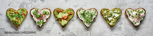 Panorama banner with stylish heart-shaped canapes on rye bread