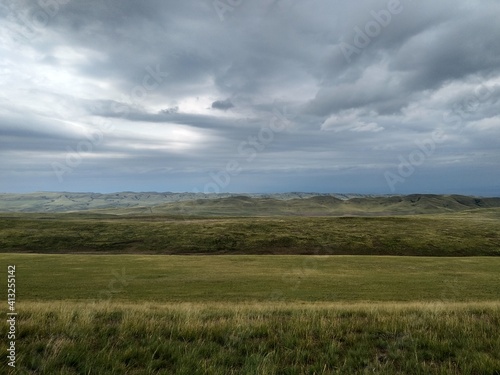Wide green landscape view with clouds