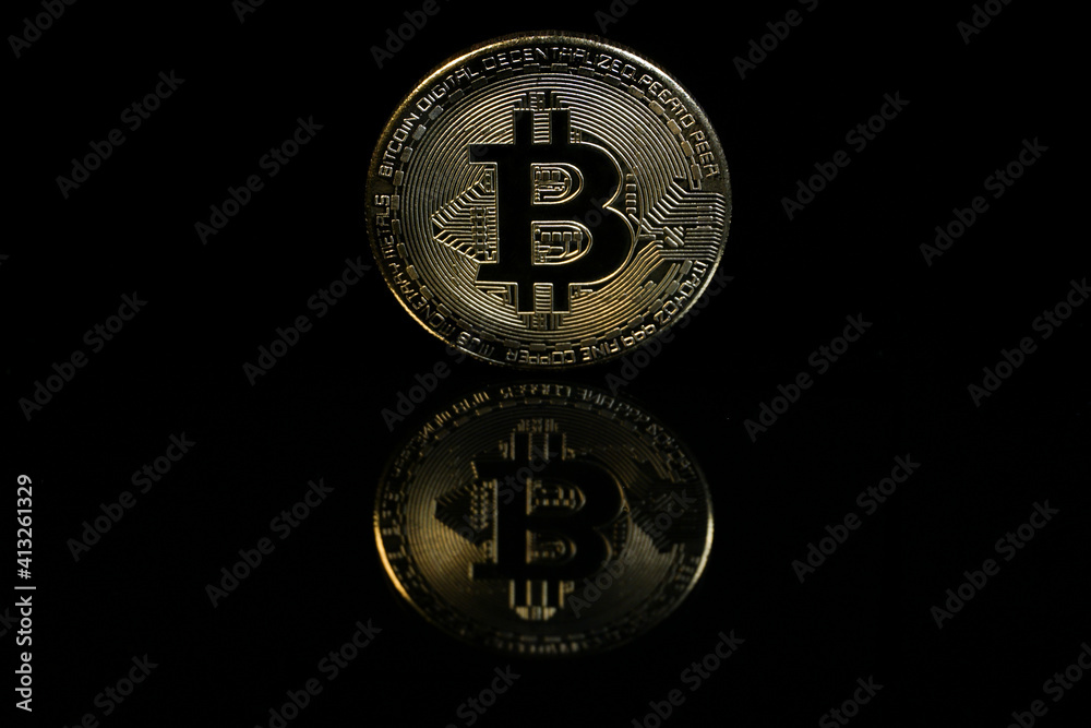 A Bitcoin with black background. Bitcoin is a digital cryptocurrency that can be exchanged for other currencies, products or services. A Bitcoin with black background. Bitcoin is a digital cryptocurrency that can be exchanged for other currencies, products or services.