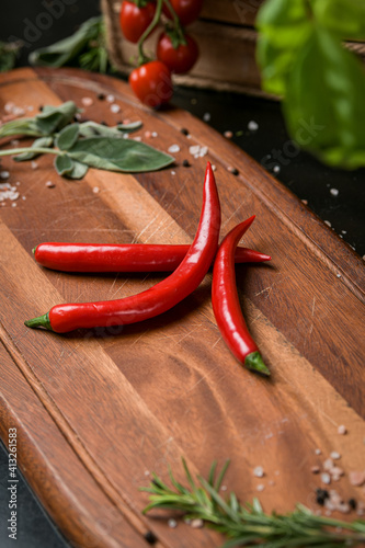 Close up view of some red hot peppers on a wood table food photography detail