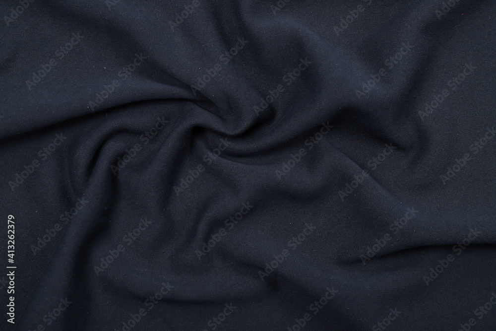 Pleats on fabric, knitted material of dark blue color, folds Pleats on fabric, knitted material of dark blue color, folds